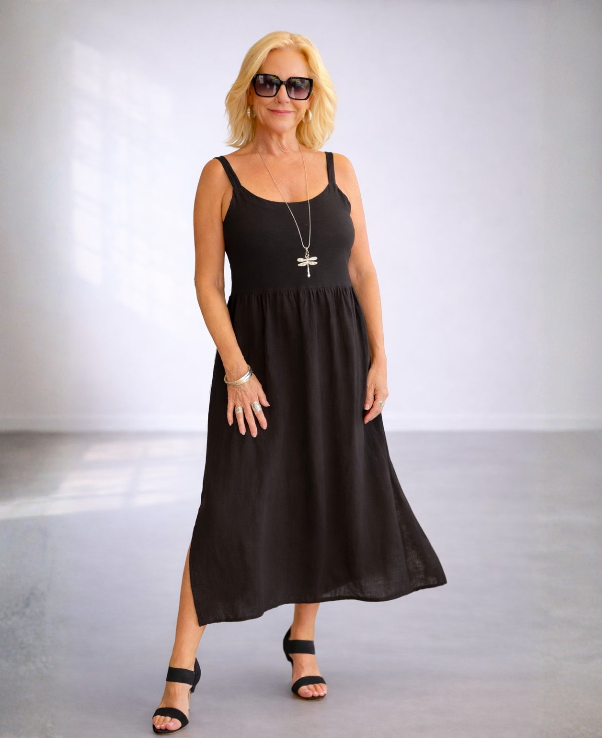Angled front view of the Ava black linen dress highlighting the soft drape and comfortable fit.