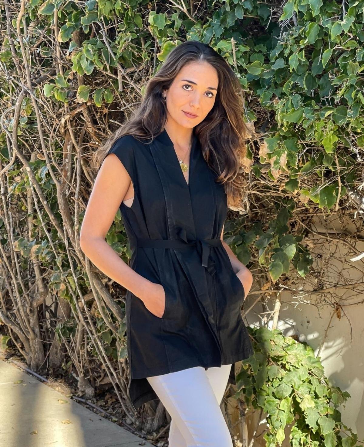 Elegant black Leia Vest crafted from waxed-finish cotton, designed with a cinched tie-up waist to enhance your shape.