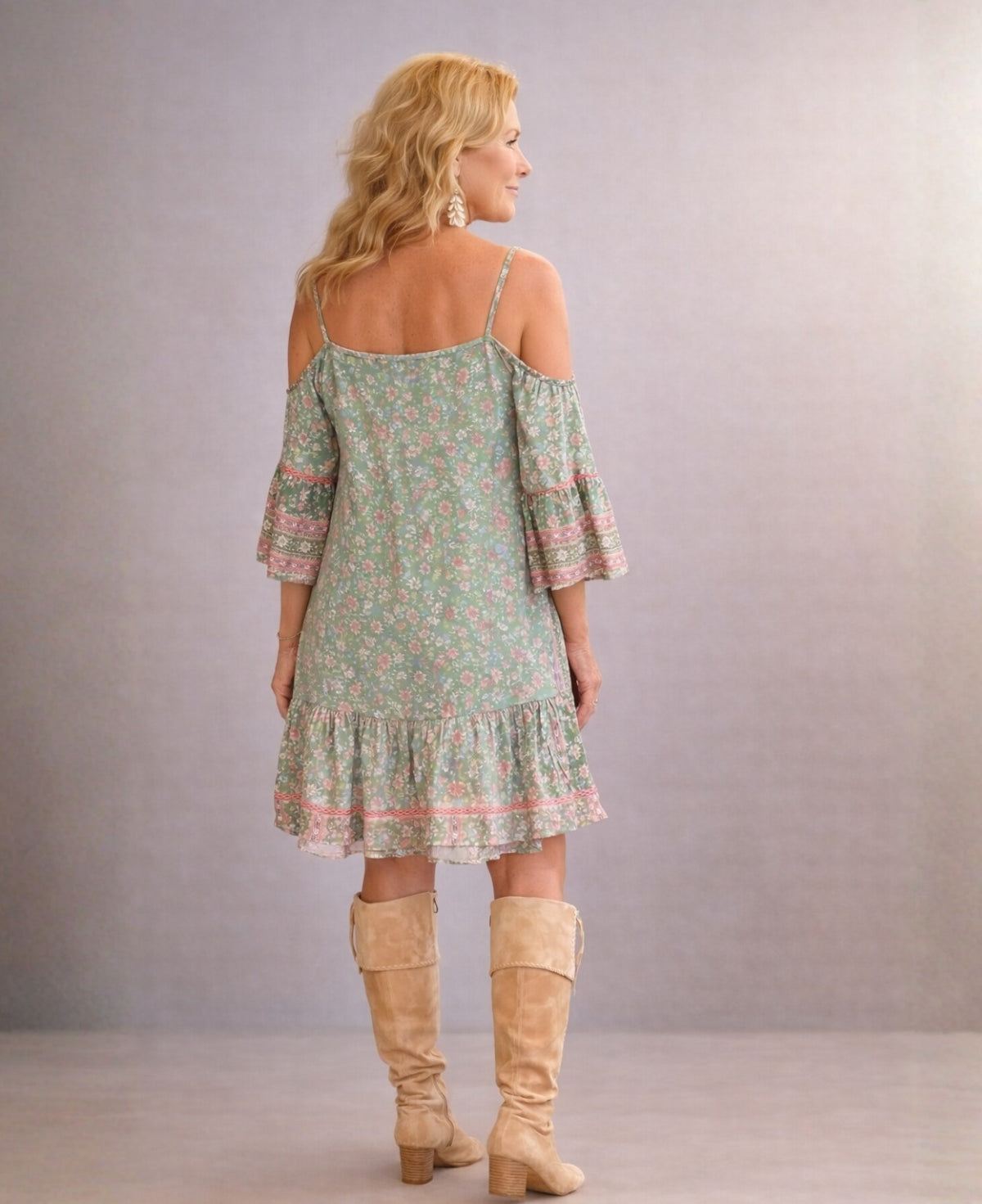 Back view of the Camellia silk dress in sage, highlighting the relaxed fit, flowing Indian silk fabric and delicate shoulder straps in a neutral studio setting.
