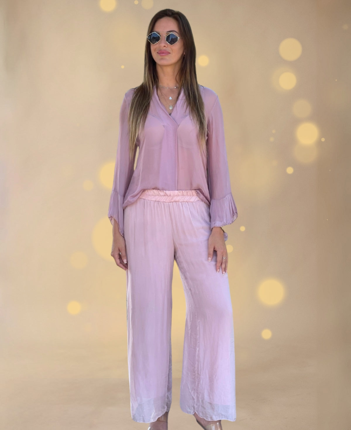 Feminine and chic Cora pants in a soft rose hue, designed with a straight wide-leg cut and a flattering, silky finish.