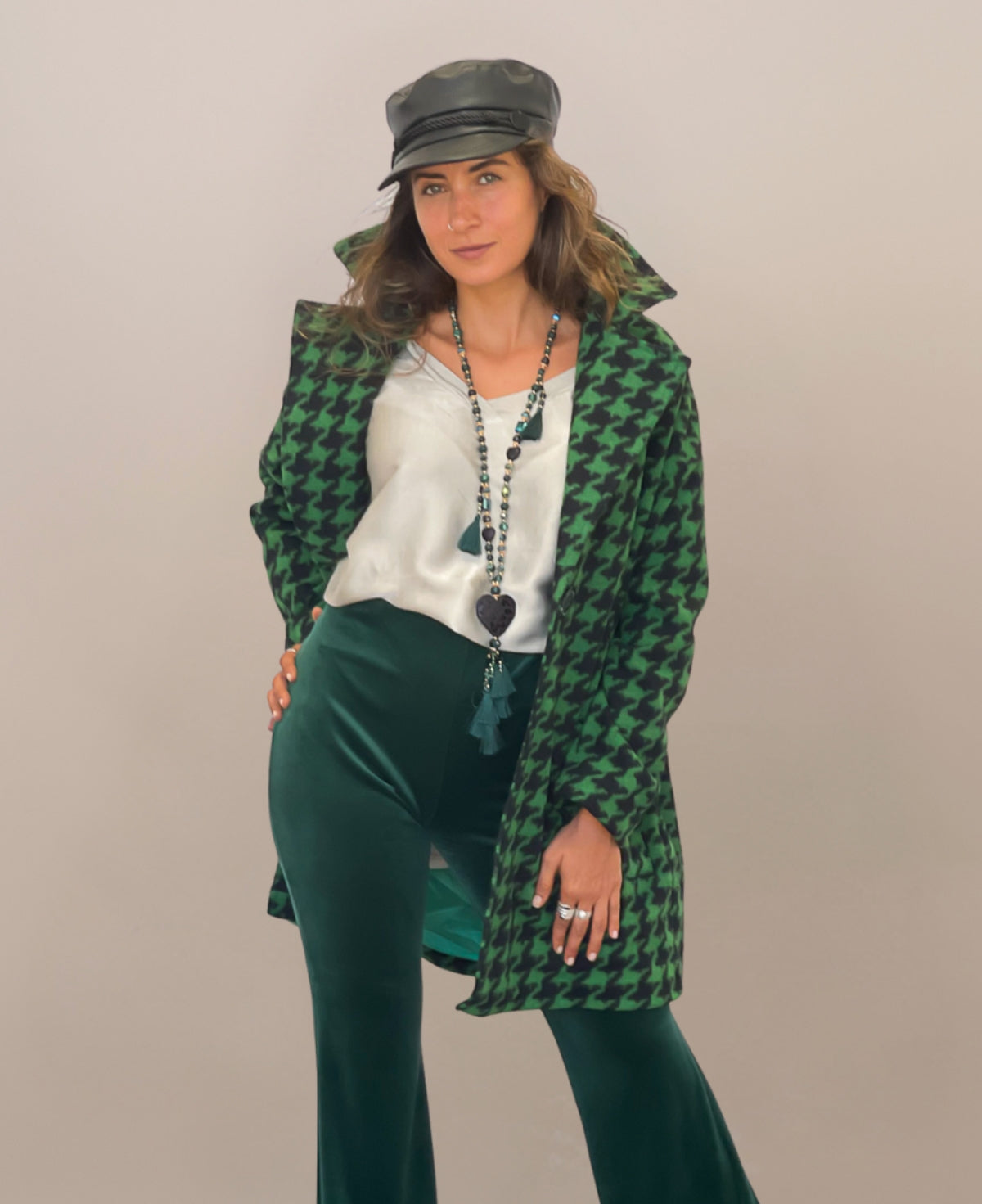 Green mid-length houndstooth-patterned coat that combines classic elegance with modern sophistication, fully lined for warmth and designed to add a refined touch to any ensemble.