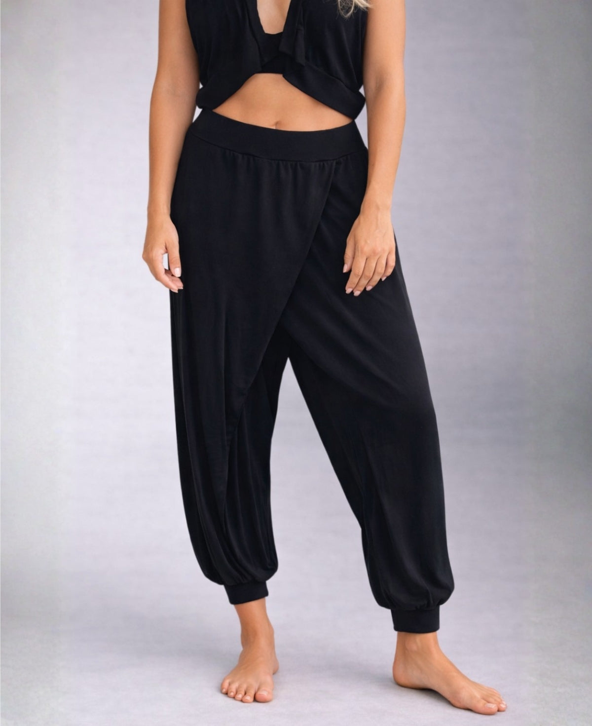 black aladina knit harem pants with crossover front design highlighting inner lining and tapered ankle cuffs
