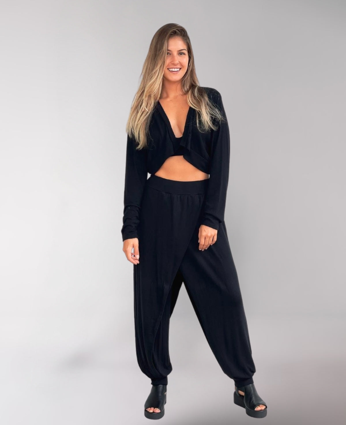 Front view of black Aladina Knit Harem Pants with a sleek pull-on style, ribbed waist, and soft rayon lining for versatile activewear