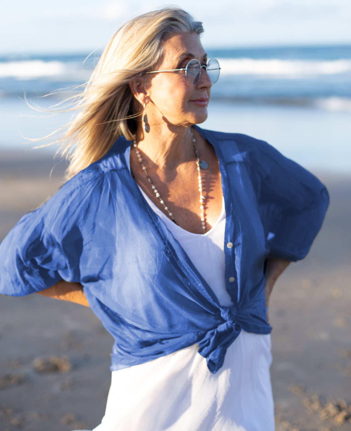 Close-up of Blue Heaven silk blend shirt, highlighting the delicate fabric texture, refined details, and charming buttoned elegance