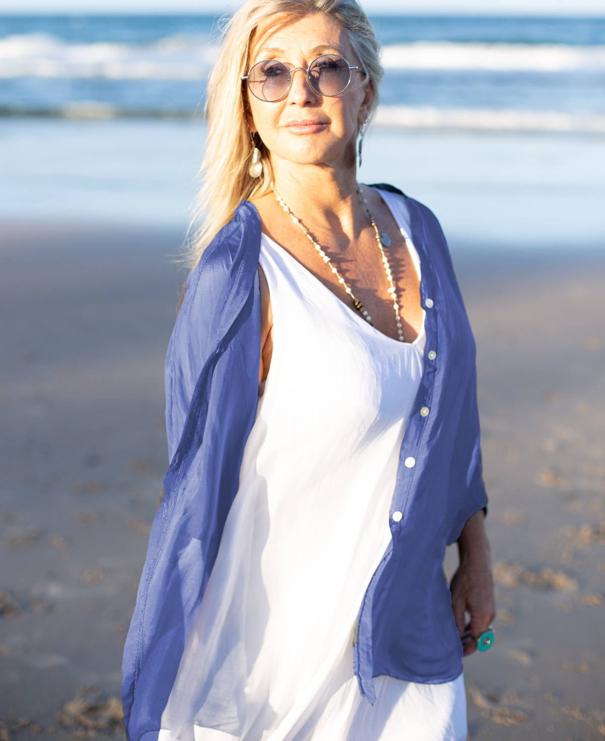 Side view of Blue Heaven silk blend shirt displaying its sleek silhouette and versatile layering design for a contemporary, chic look.