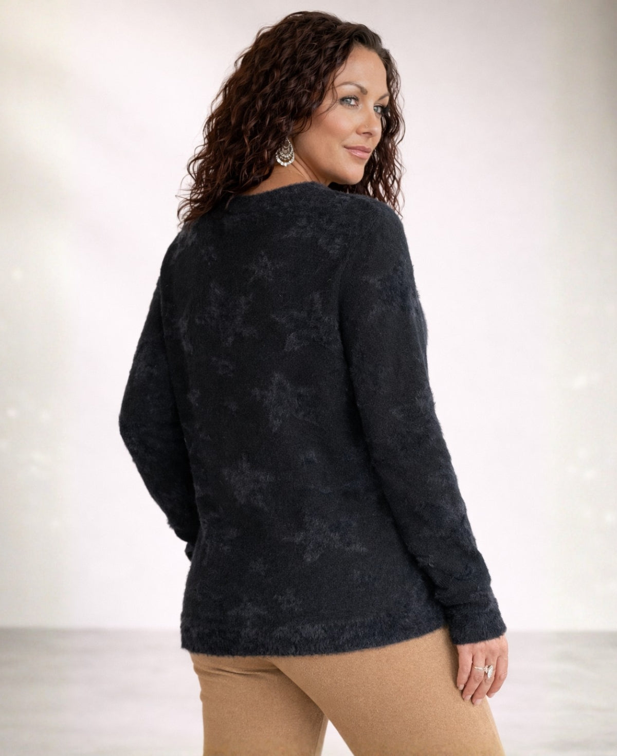 Black star motif viscose blend sweater shown from back angled view on model