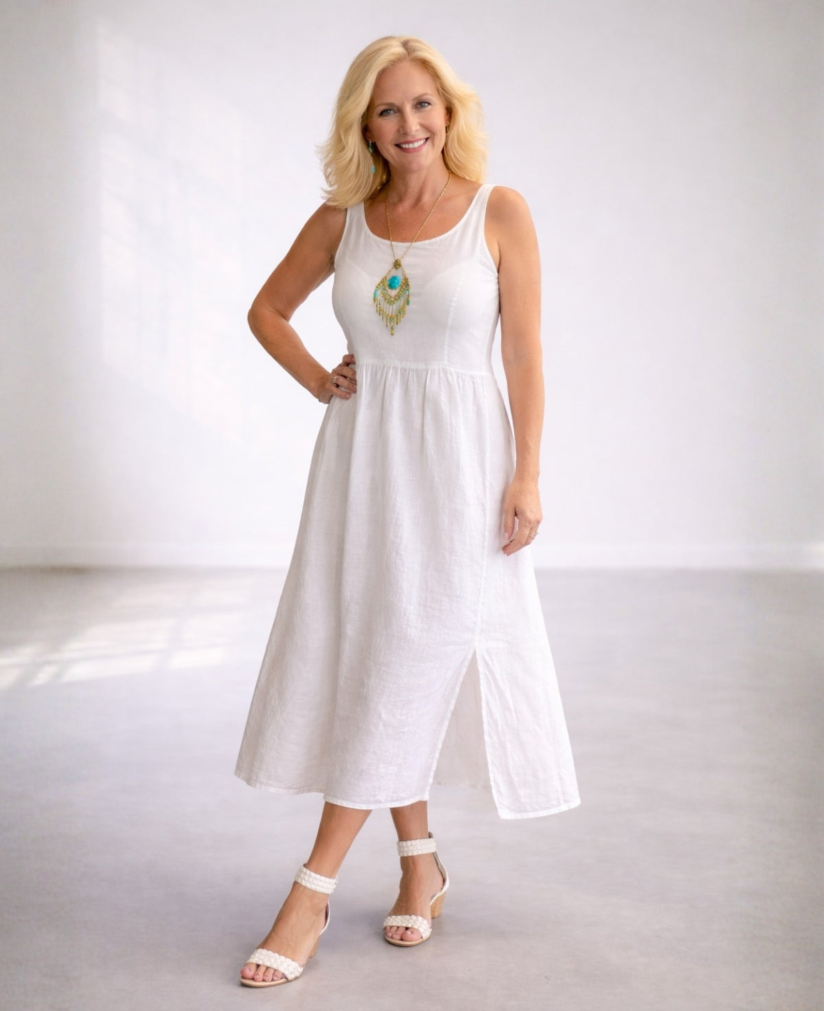 Angled front view of the Ava white linen midi dress with easy fit and breathable linen fabric.