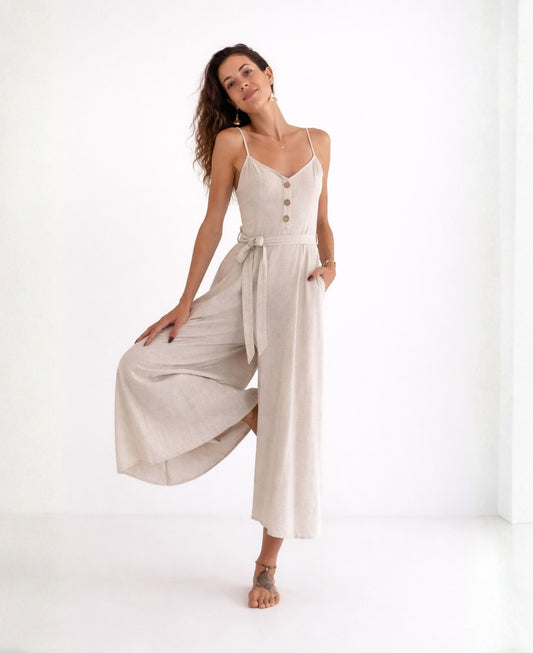 Studio image of the Bella Byron Linen Jumpsuit in ivory, highlighting the tailored bodice, front button detail, waist belt and fluid cropped palazzo legs under soft natural lighting.