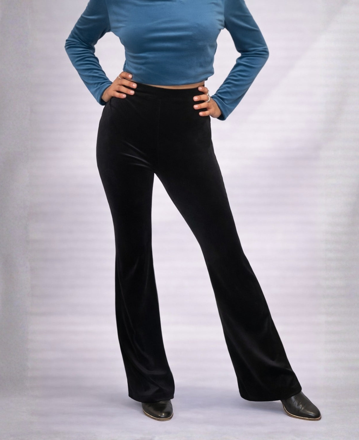 Close-up side view of Black Marshmallow Velour flare pants showing velour texture, high waist and relaxed flared leg