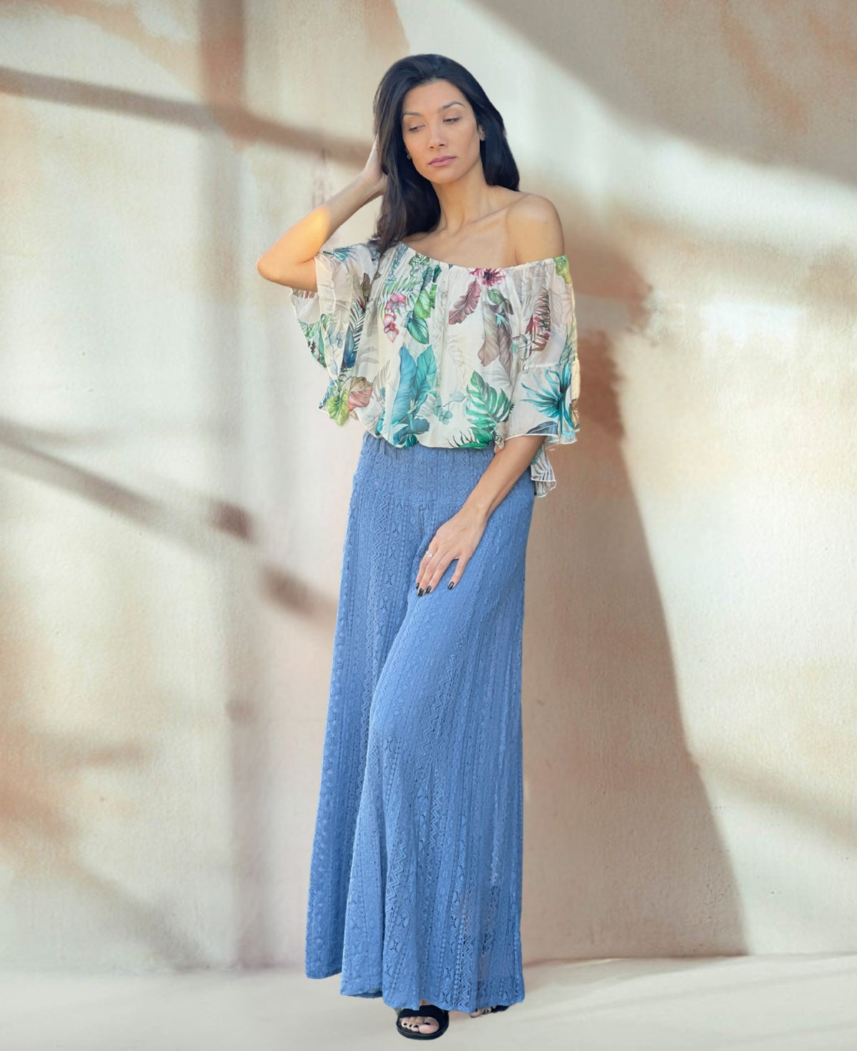 Blue-Heaven palazzo pants crafted from delicate cotton lace with floral detailing, showcasing an extra-wide flare and comfortable shirred waist for a vintage boho look.