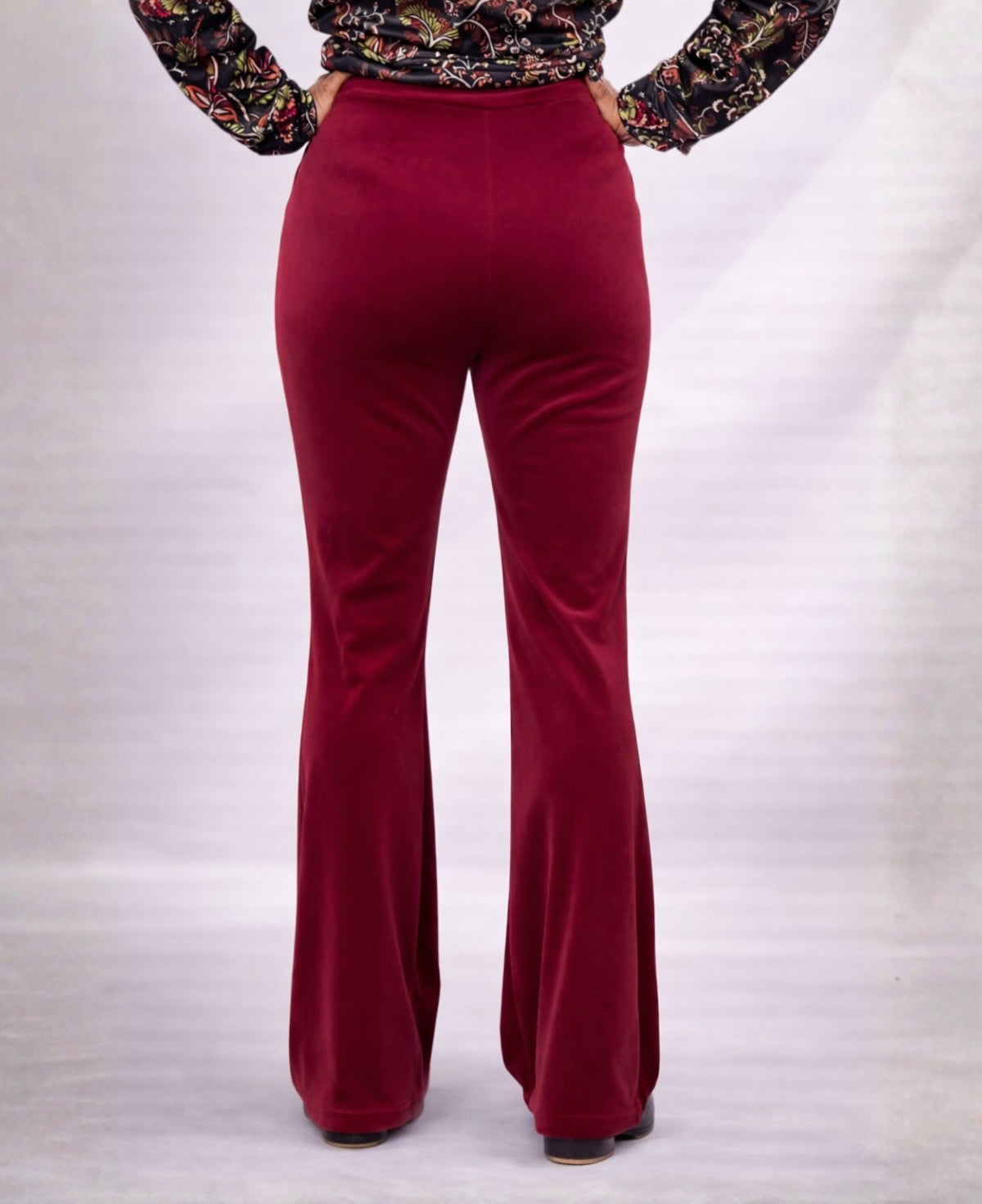 Back view close-up of Bordeaux Marshmallow Velour flare pants highlighting fit through the waist and hips with flared hem
