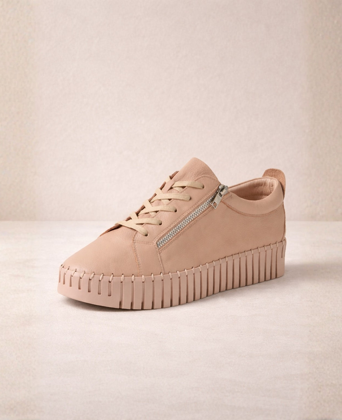 Angled front view of Bump Rose Leather Sneakers showing premium leather upper, lace-up closure, zip trim and chunky platform sole