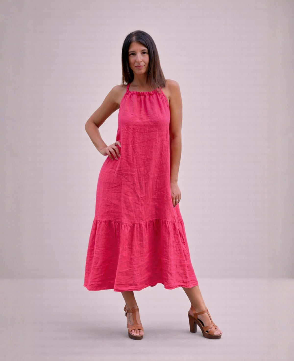 Front view of the Cassey linen dress in strawberry pink, showcasing vibrant colour, relaxed shape and tiered midi length.