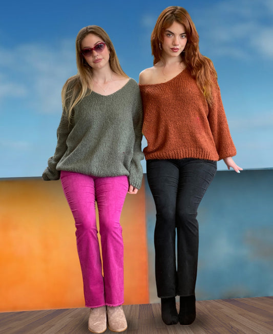 Stylish fashion shot of two models wearing fuchsia and black jeans with a refined classic cut, highlighting premium cotton corduroy and a contemporary edge.