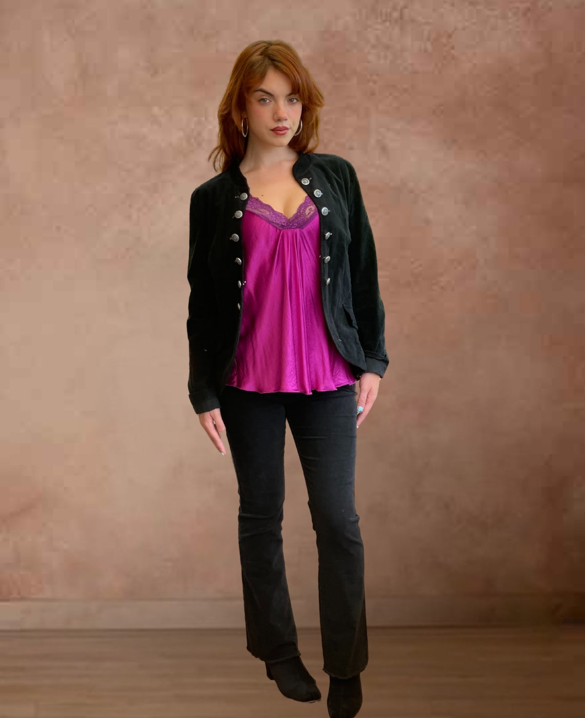Black corduroy jeans highlighting the sleek zipper closure, refined fine ribbing, and delicate frayed leg hems
