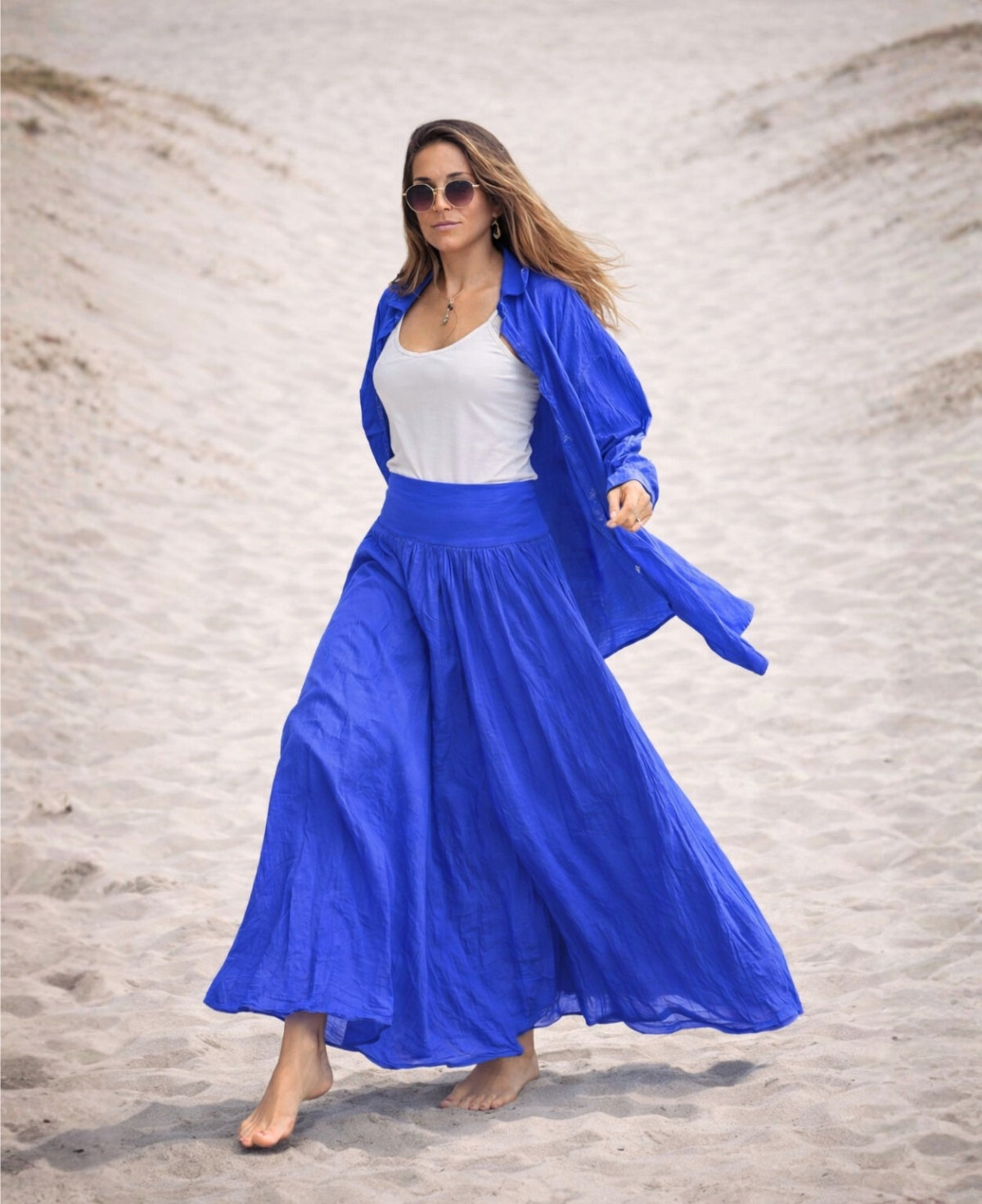 Cotton voile convertible maxi skirt in cobalt blue worn as a skirt on the beach with soft flow and stretch waist