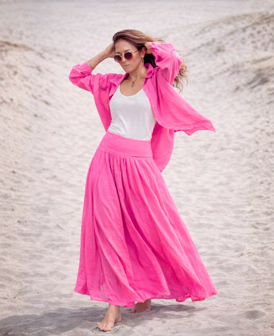 Cotton voile convertible maxi skirt in fuchsia worn as a skirt on the beach with flowy silhouette and stretch waistband