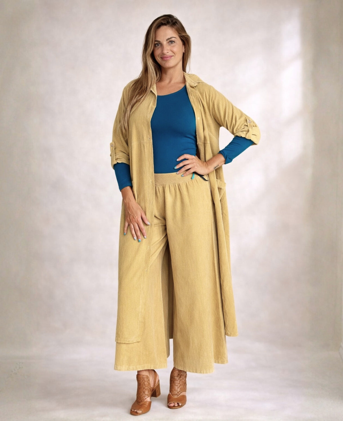 Angled front view of Demi Corduroy Pants in Light Camel showing wide-leg fit, fine ribbed corduroy fabric, and stretch waist.