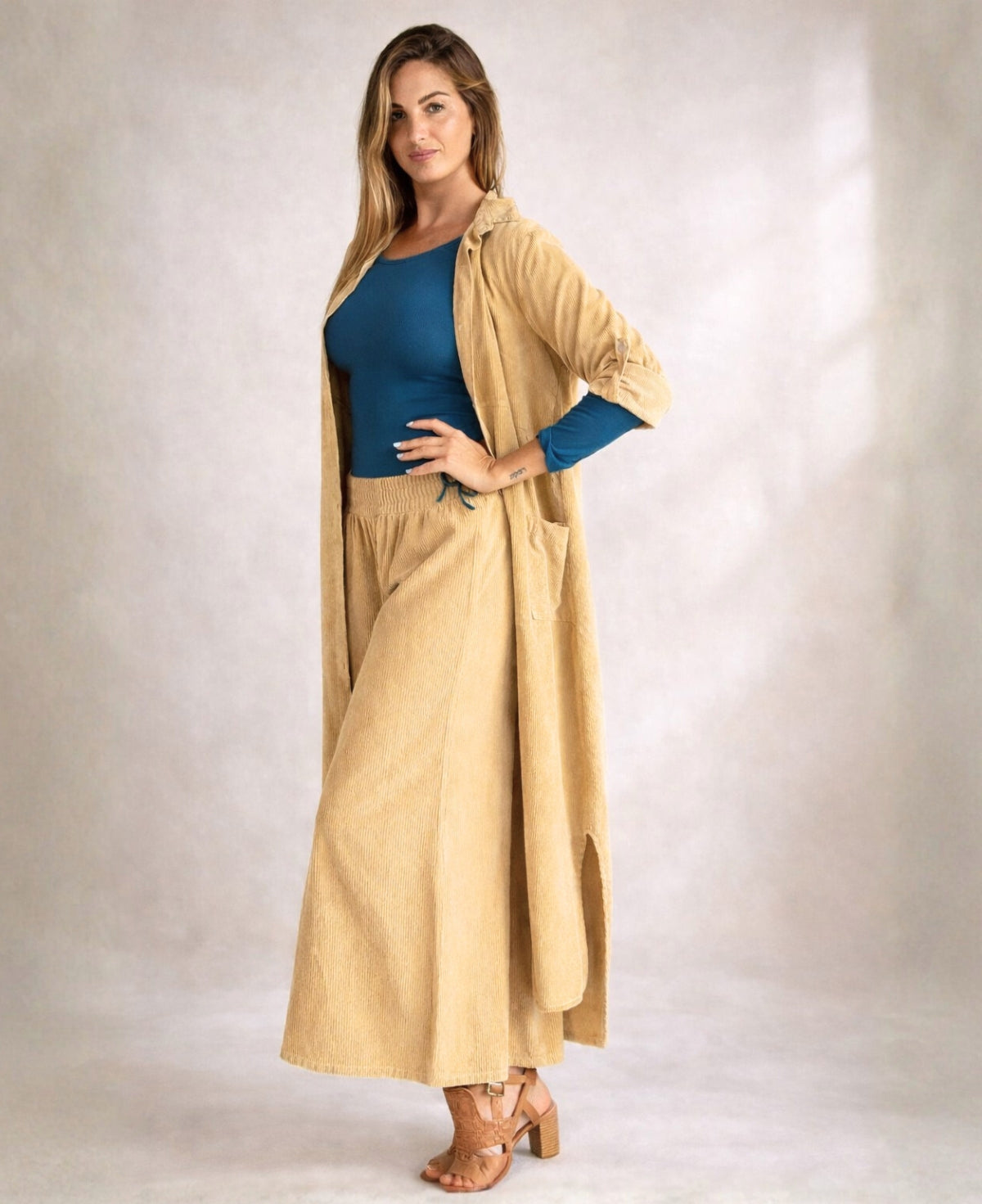 Model wearing Demi Corduroy Pants in Light Camel, wide-leg fine ribbed corduroy pants with stretch waistband.