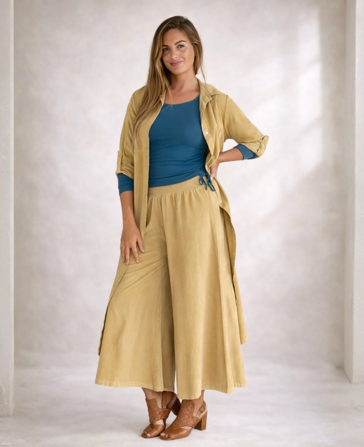 Side view of Demi Corduroy Pants in Light Camel showing soft corduroy fabric and relaxed long leg.