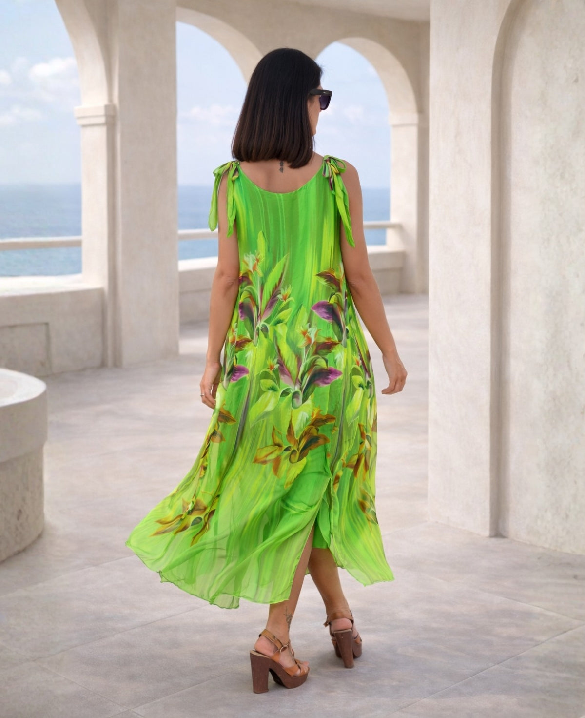 Back view of Dior Silk Dress in emerald green silk with floral print, featuring sheer tie shoulder straps and flowing hem