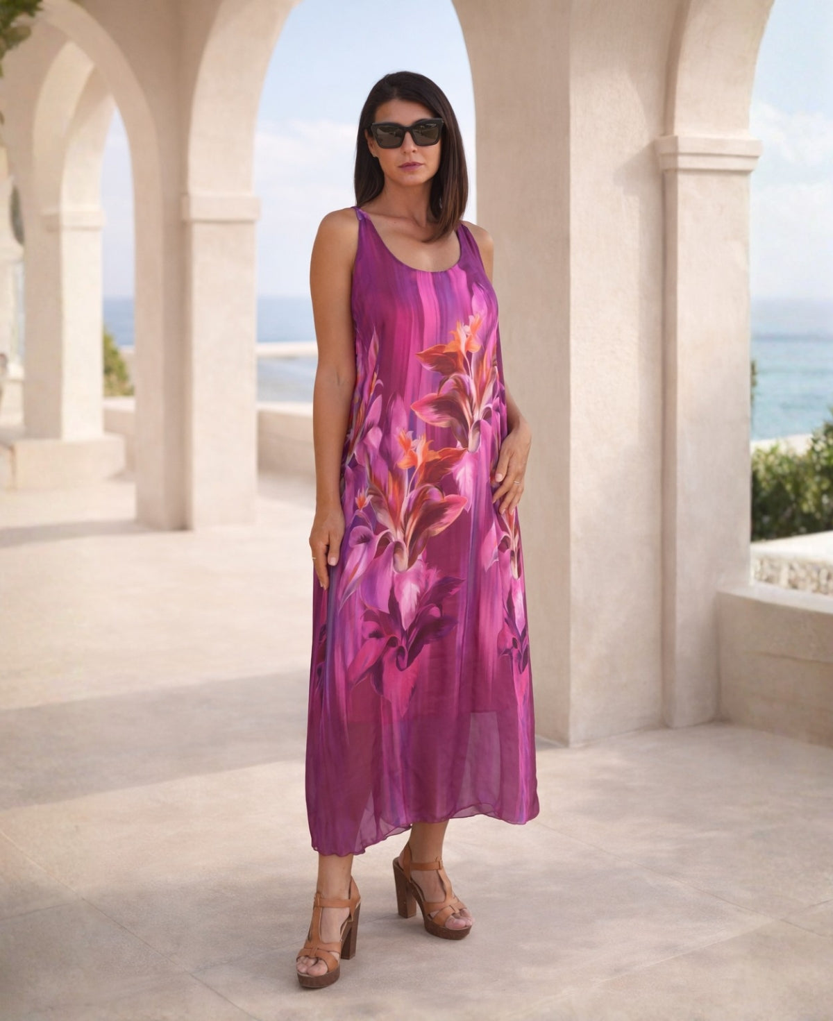 Dior Silk Dress in vibrant sangria color floral print, front view, flowing silk midi dress styled in a Mediterranean architectural setting
