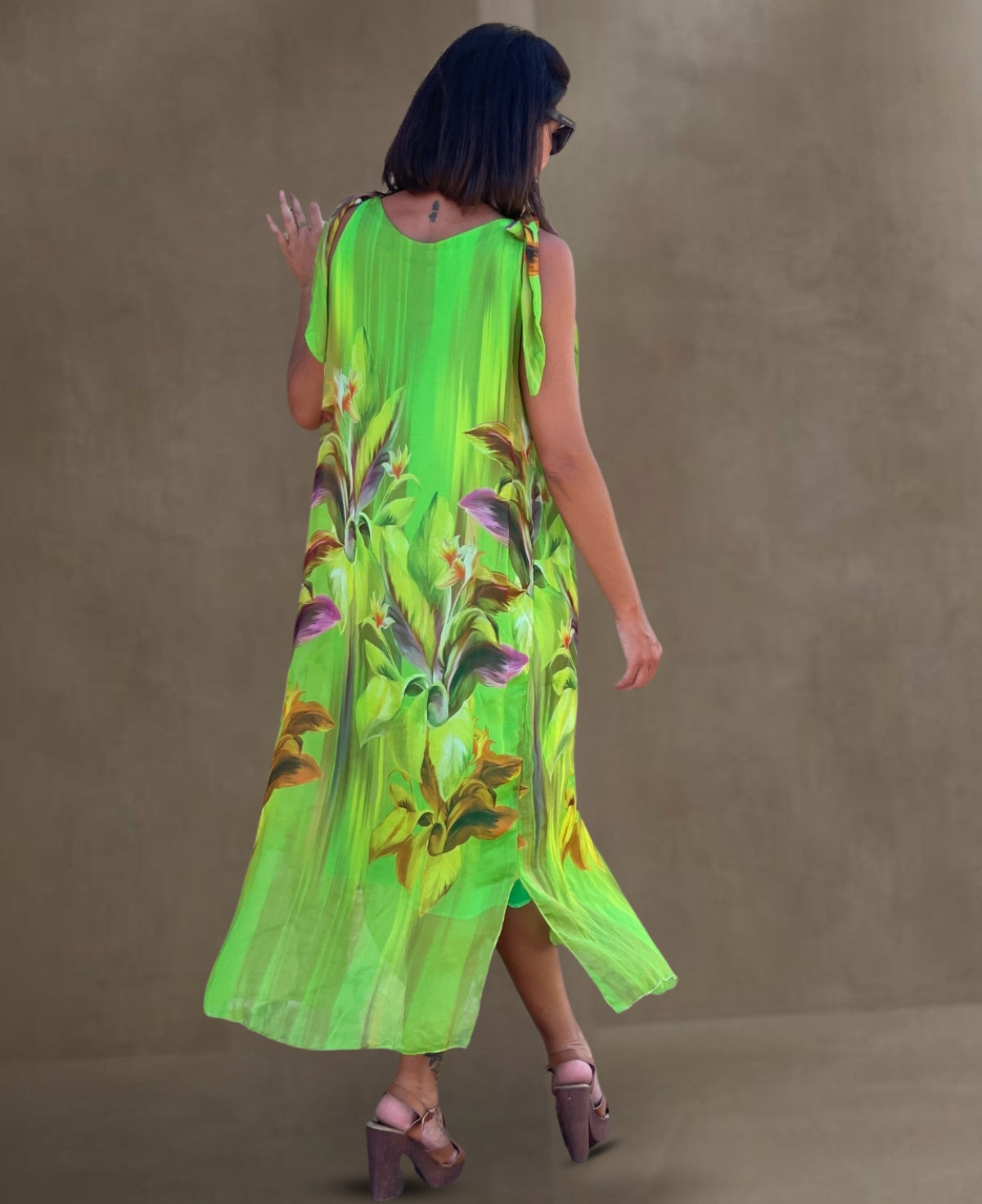 Back view of the bold emerald Dior Silk Dress, showcasing its lightweight rayon lining and refined design details that exude elegance