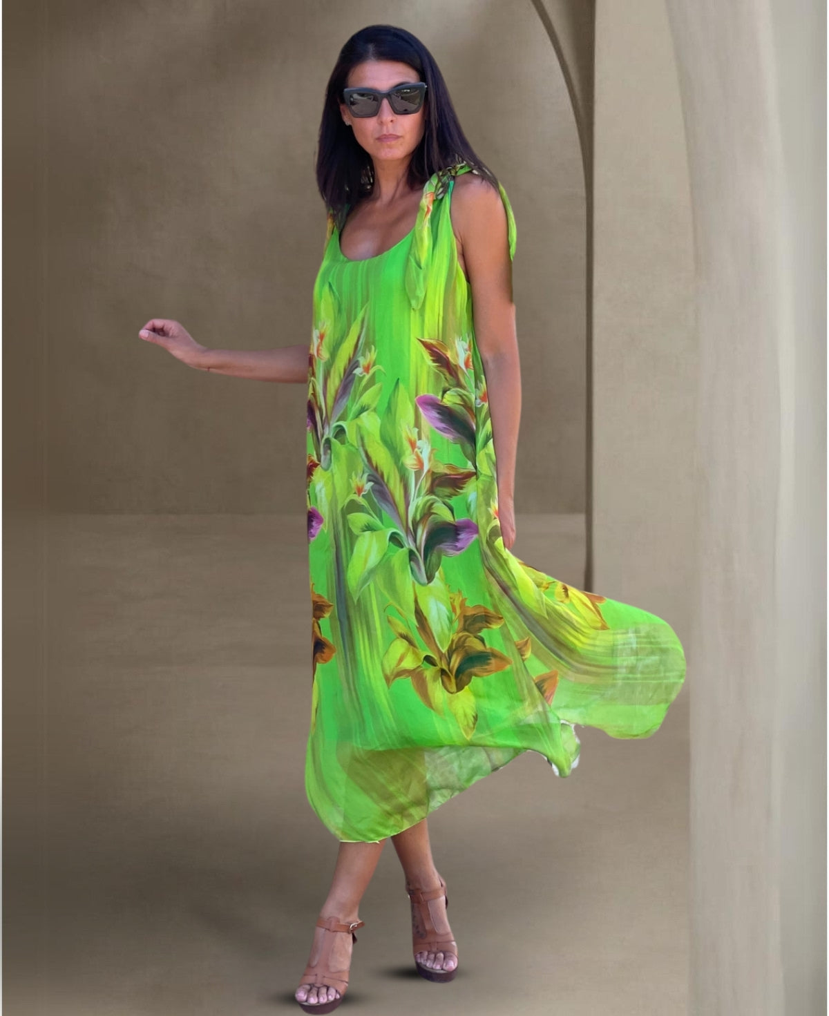 Front view of the Dior Silk Dress in bold emerald, featuring an eye-catching floral print, elegant tie straps, and a flattering scoop neckline