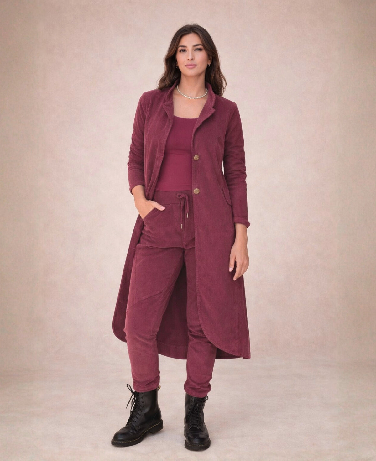 Burgundy Dylan corduroy jacket worn with matching pants and black boots