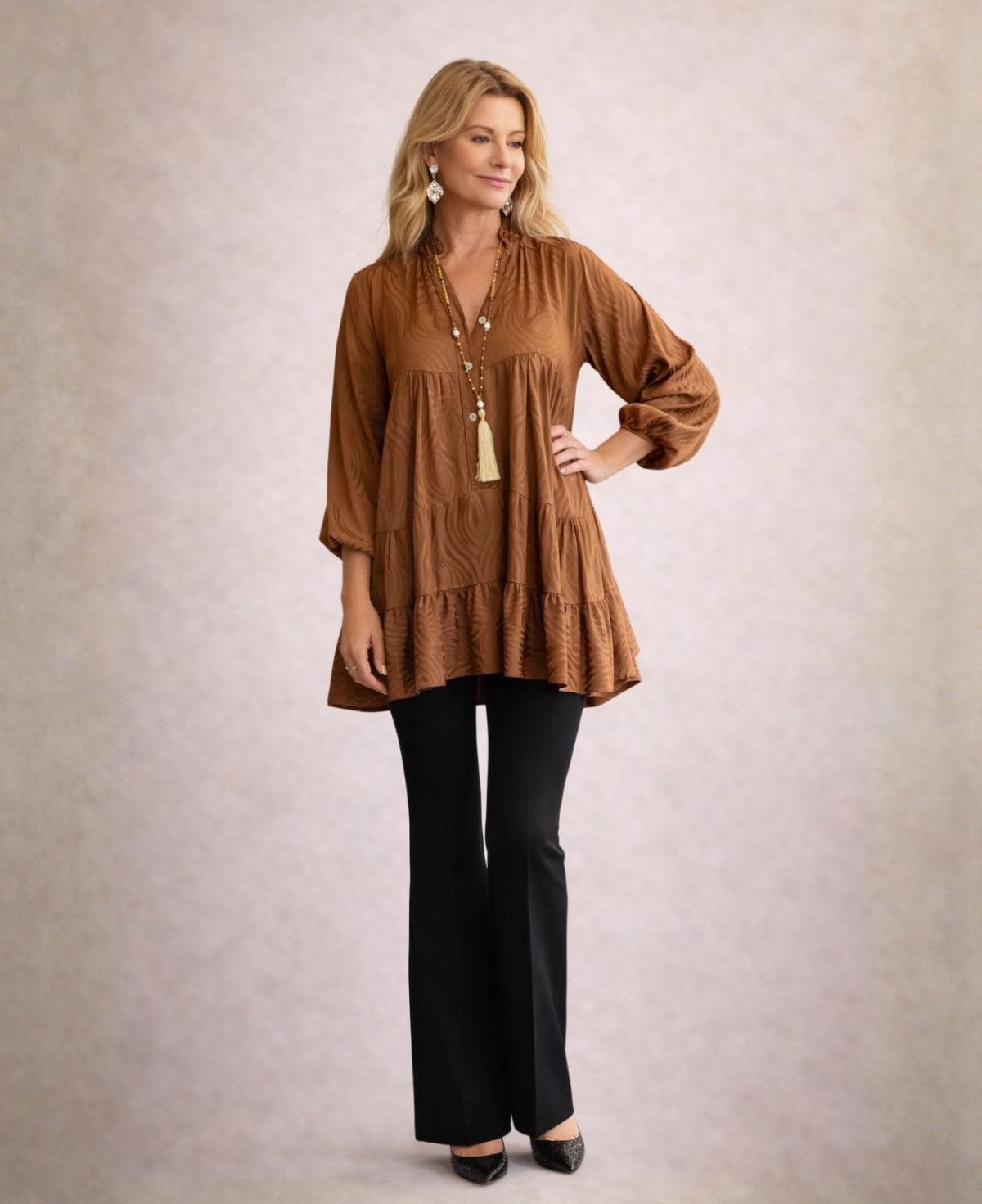 Editorial view of the copper Eden Pattern satin top highlighting satin sheen, embossed pattern and flowing silhouette.