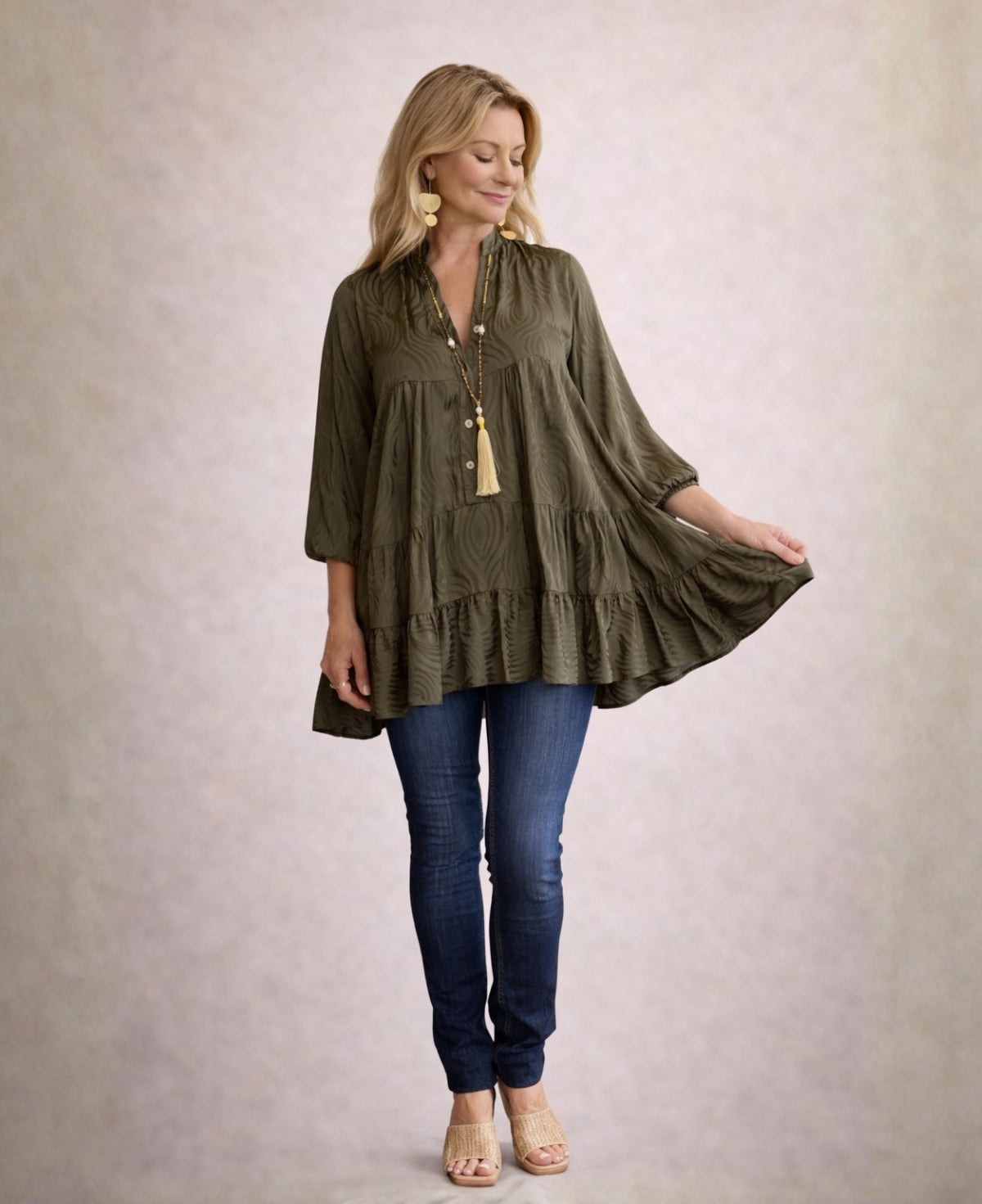 Olive Eden Pattern satin top styled over jeans, featuring embossed satin detailing and soft winter layering look.