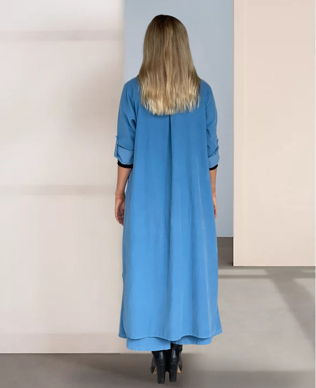 Back view of the Blue Heaven Empire Fraya Corduroy Dress, showcasing its flowing silhouette and refined style.
