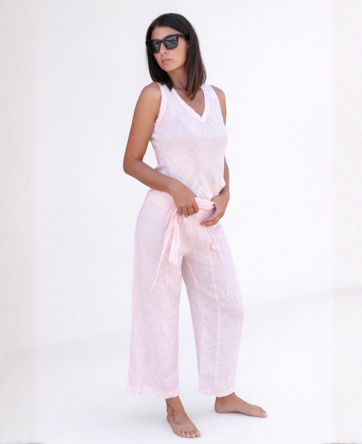 Model wearing Florence Linen Palazzo Pants in Blush, featuring a wide-leg palazzo cut, stretch waist with tie, and lightweight textured linen fabric.