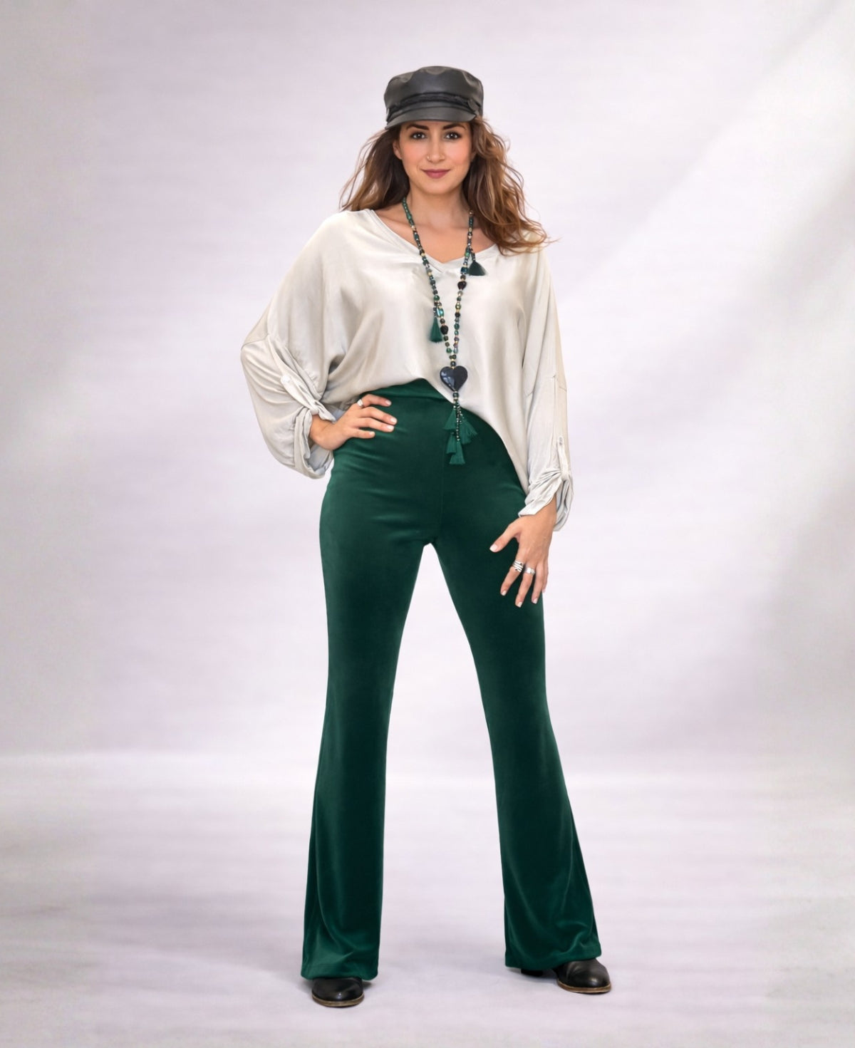 Model wearing Forest Green Marshmallow Velour flare pants styled with a neutral top, shown in a full body front view under soft studio lighting