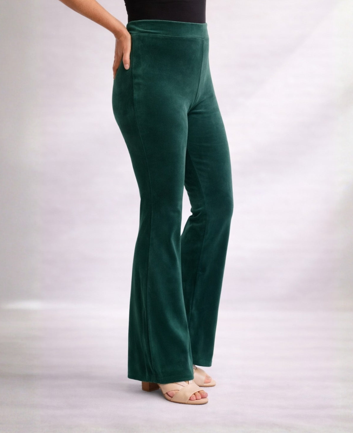 Close-up side view of Forest Green Marshmallow Velour flare pants showing smooth velour texture and flared leg shape