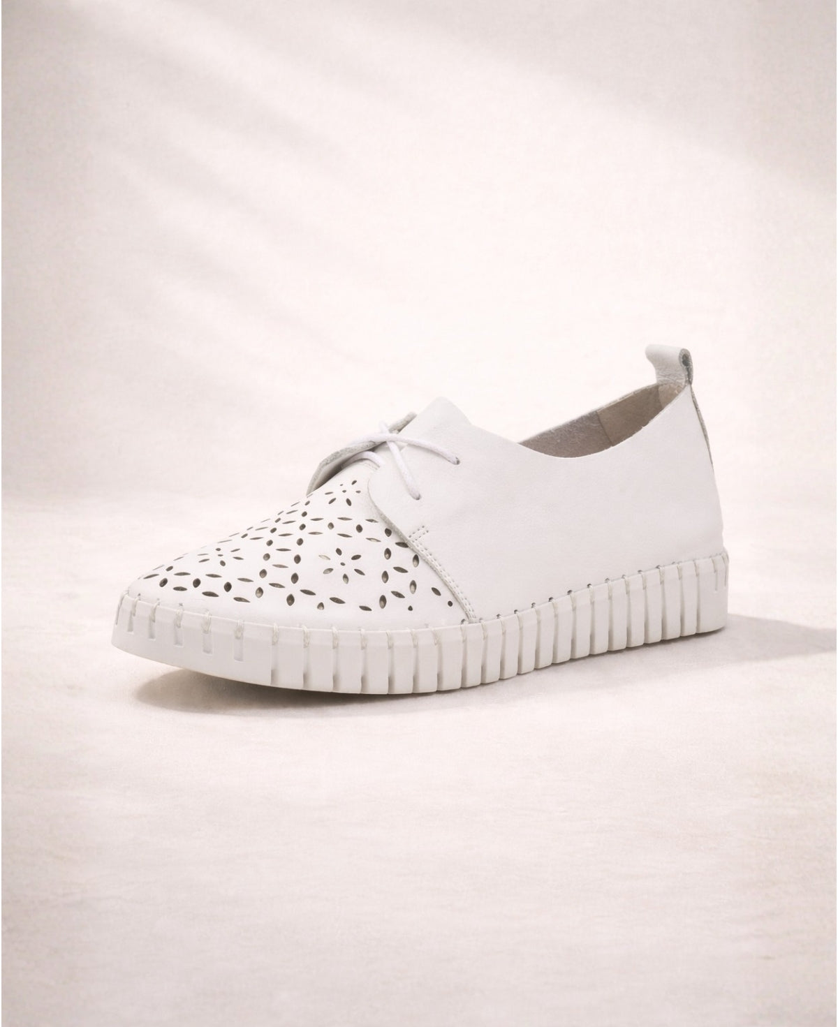Angled side view of Hexter white leather sneakers highlighting the smooth leather upper and cleated sole