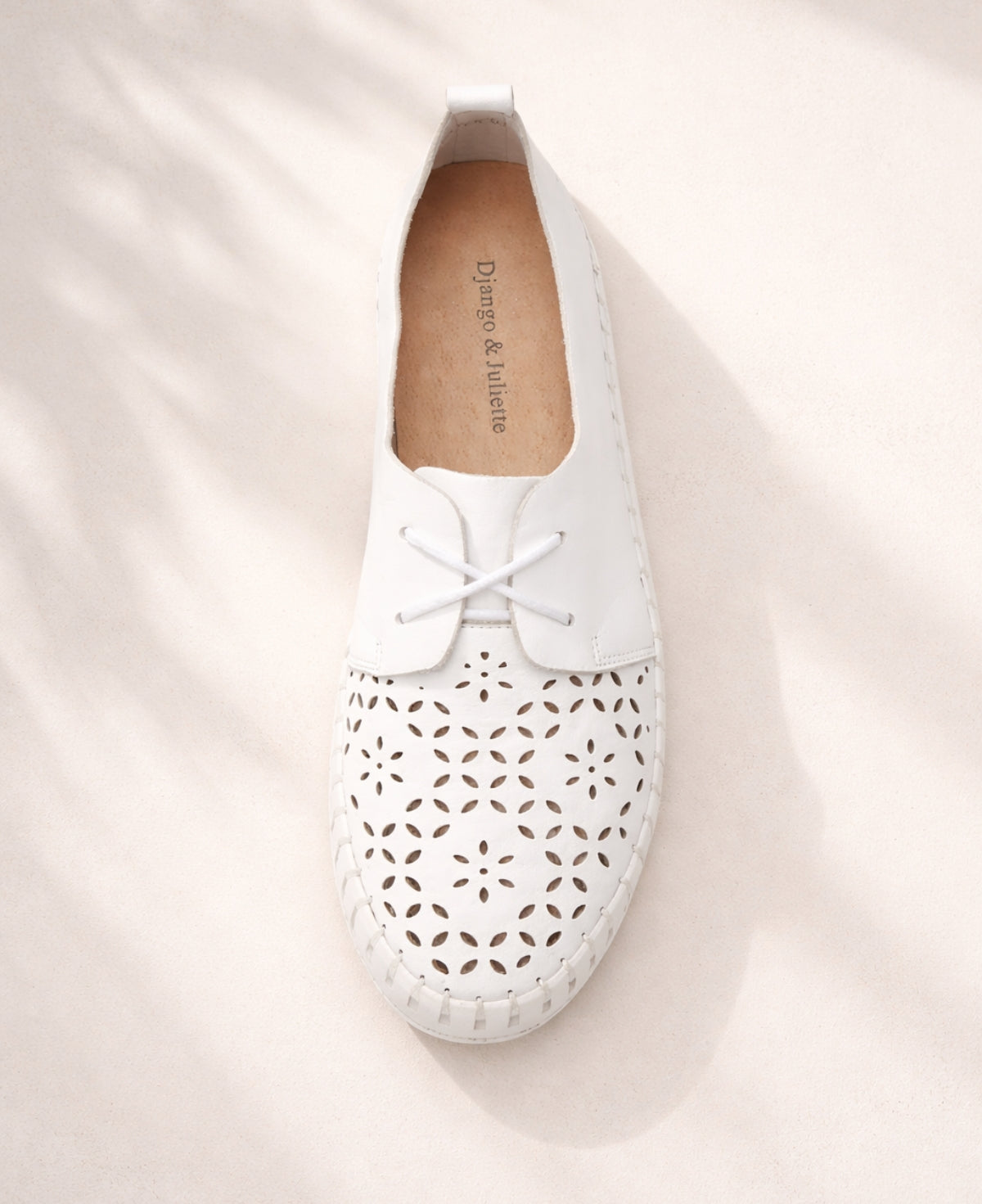 Top view of Hexter white leather sneakers showing lace-up design and laser-cut leather detailing on the toe
