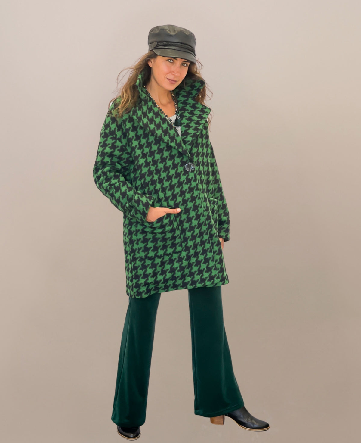 Green mid-length houndstooth-patterned coat that combines classic elegance with modern sophistication, fully lined for warmth and designed to add a refined touch to any ensemble.