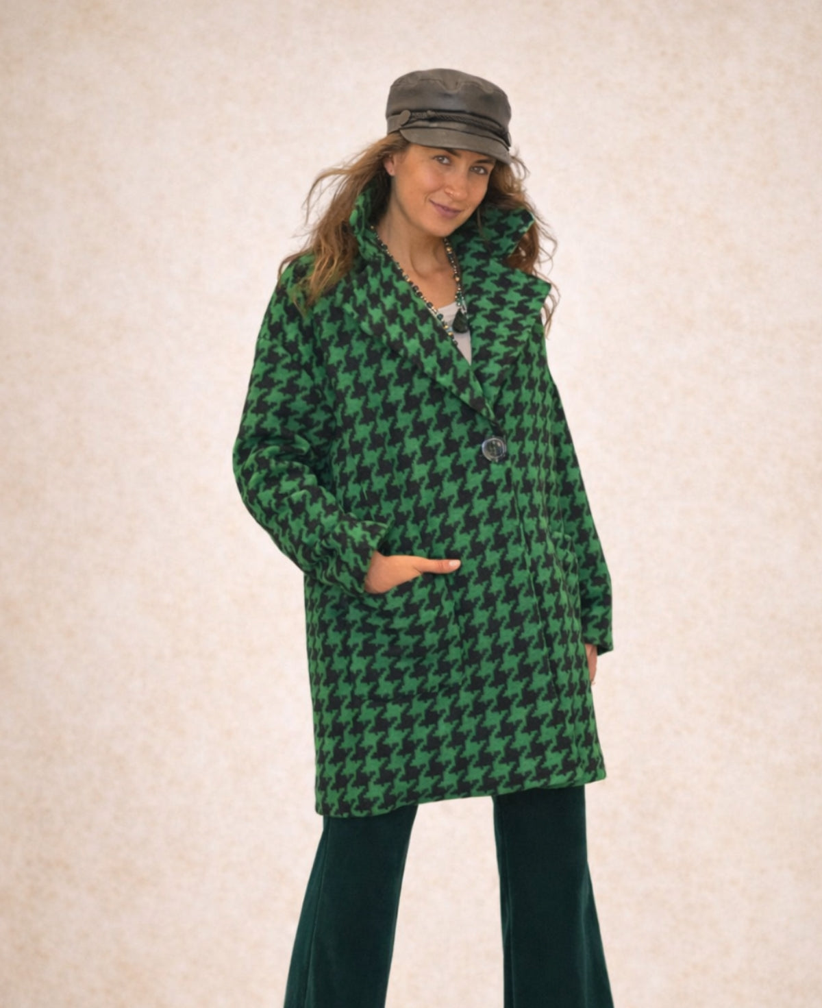 Green mid-length houndstooth-patterned coat that combines classic elegance with modern sophistication, fully lined for warmth and designed to add a refined touch to any ensemble.