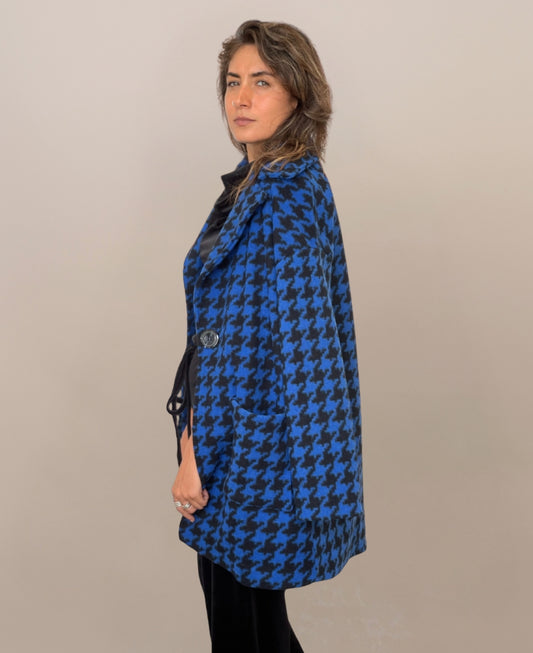 Royal blue mid-length houndstooth-patterned coat, seamlessly blending classic elegance with modern sophistication, fully lined for warmth and a chic alternative to the traditional long overcoat.