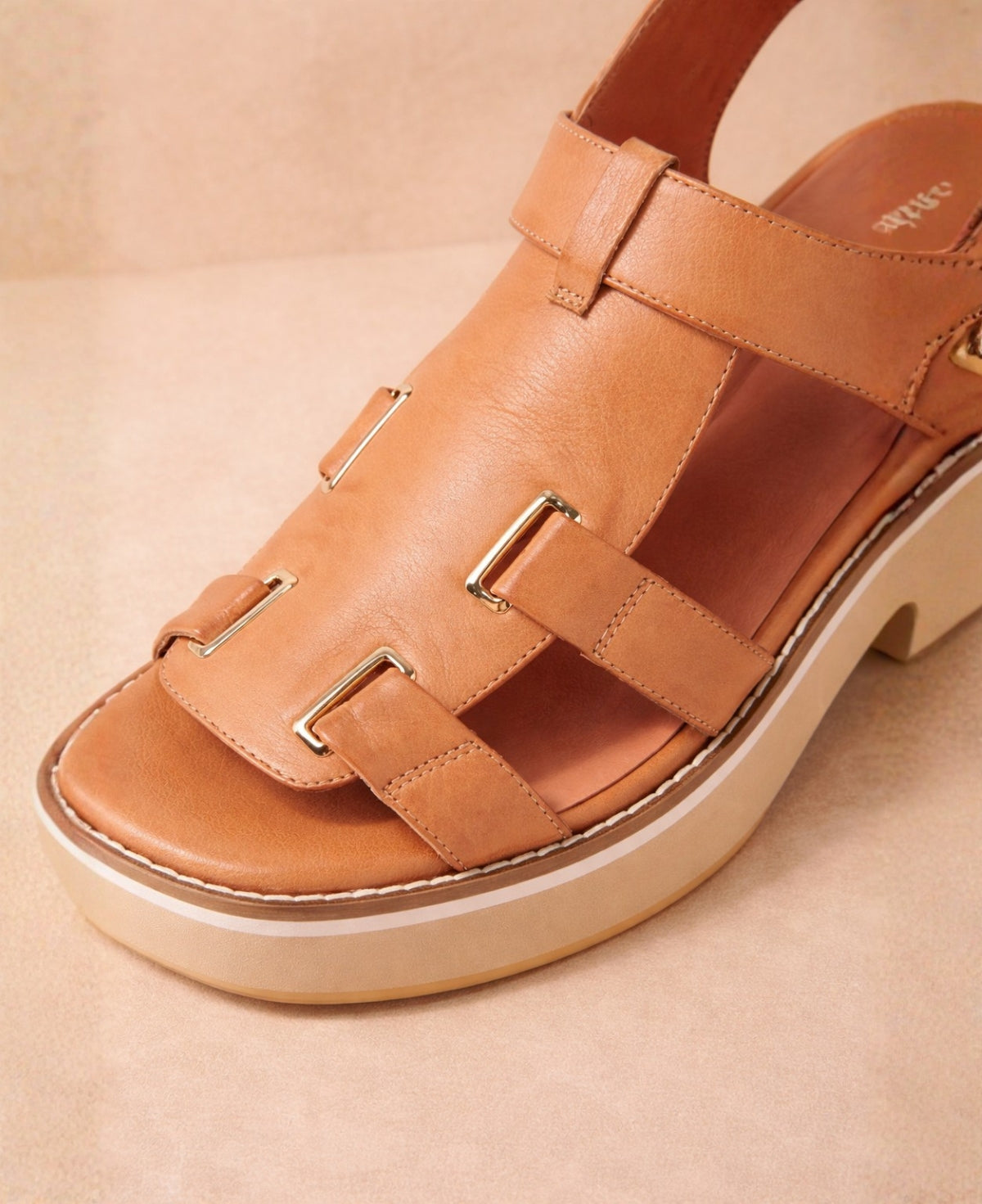 Detail view of Jennis tan leather sandals highlighting adjustable straps and smooth leather finish