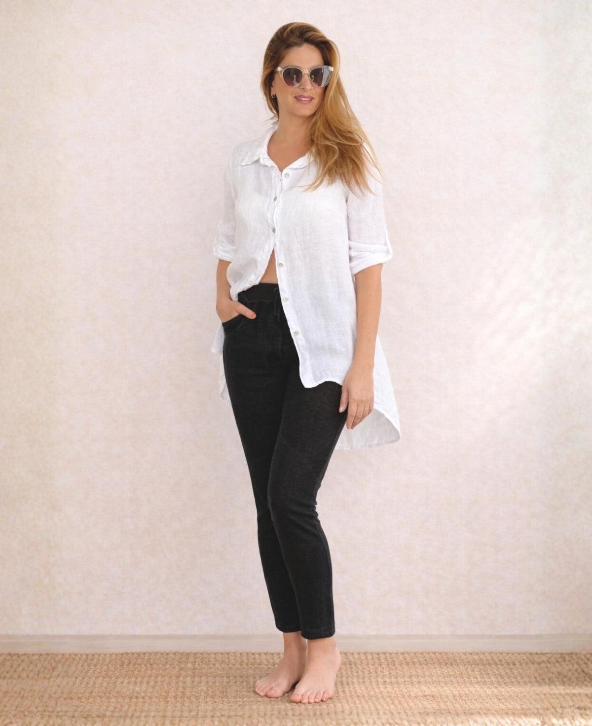 Full body front view of the Jordan Linen Pants in black styled with white linen shirt, showing seam detail and stretch waist.