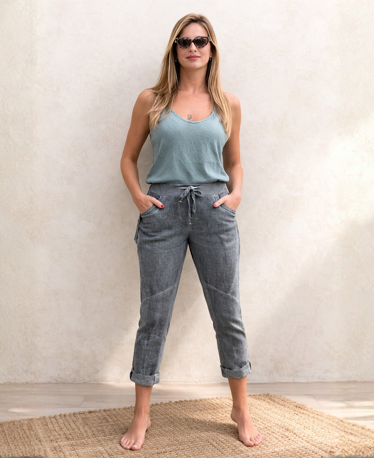 Full body front view of the Jordan Linen Pants in grey with rolled hems, narrow leg shape and ribbed stretch waistband.
