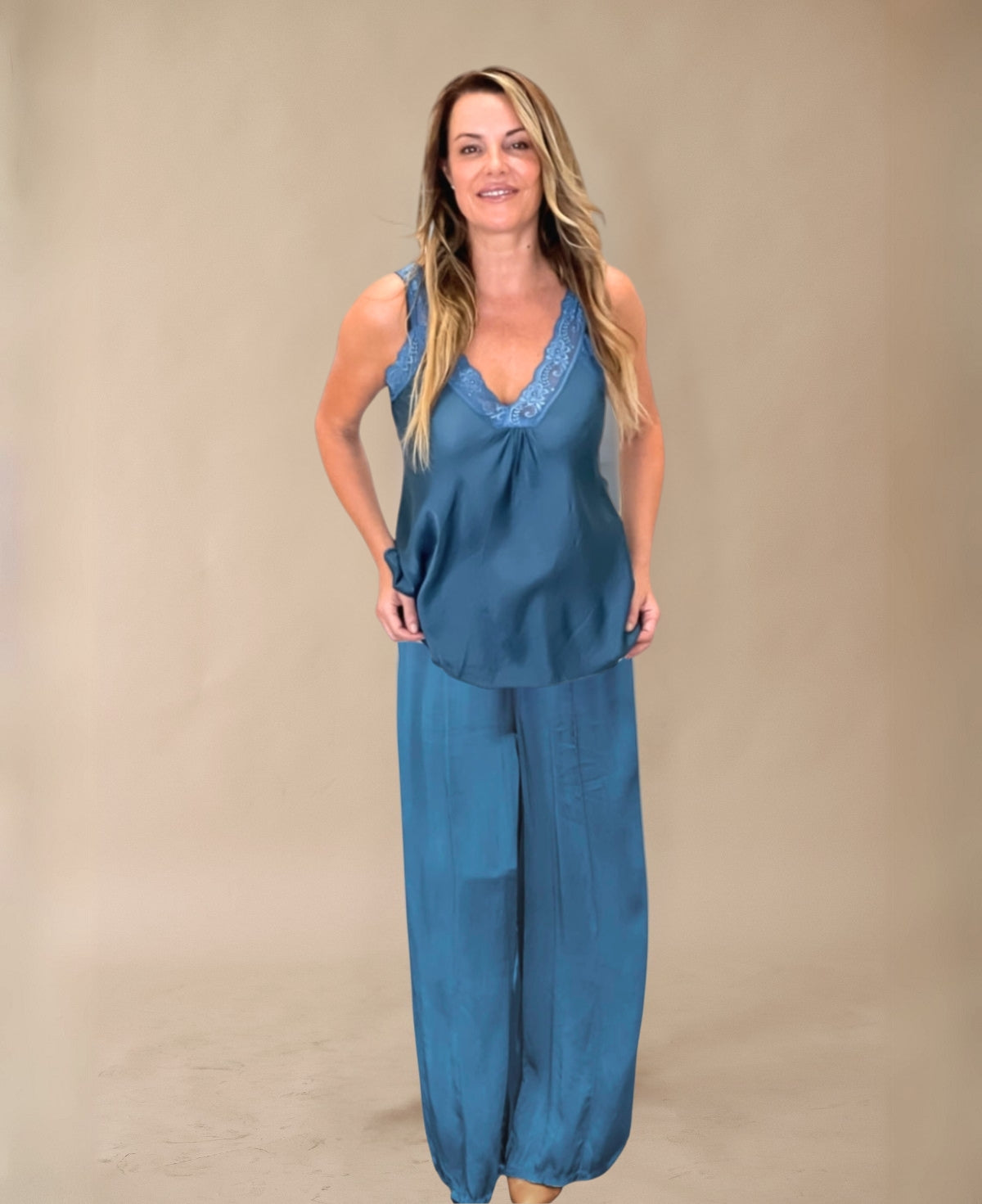 Luxurious satin wide-leg pants in deep blue teal, designed with a flowing silhouette, elastic waistband, and side pockets. A stylish and sophisticated choice for any occasion