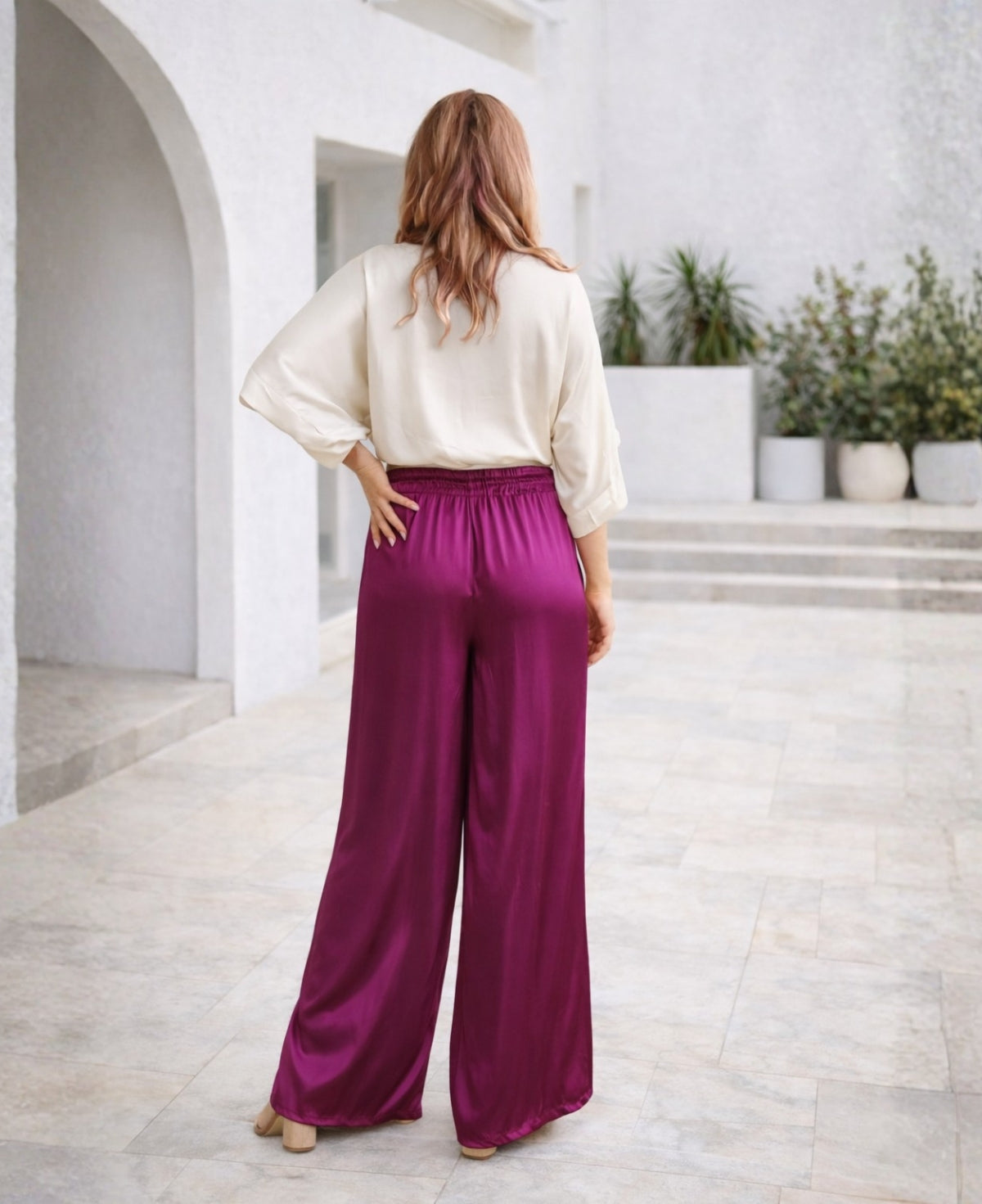 Satin wide-leg pants in rich sangria, featuring a relaxed fit, elastic waistband, and practical side pockets. A chic and versatile piece for effortless elegance