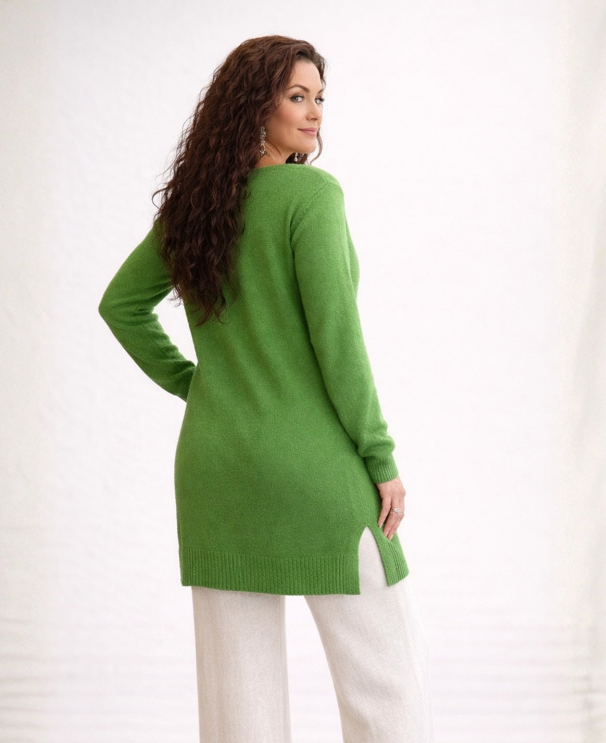 Back angled view of apple green cashmere sweater showing length and drape