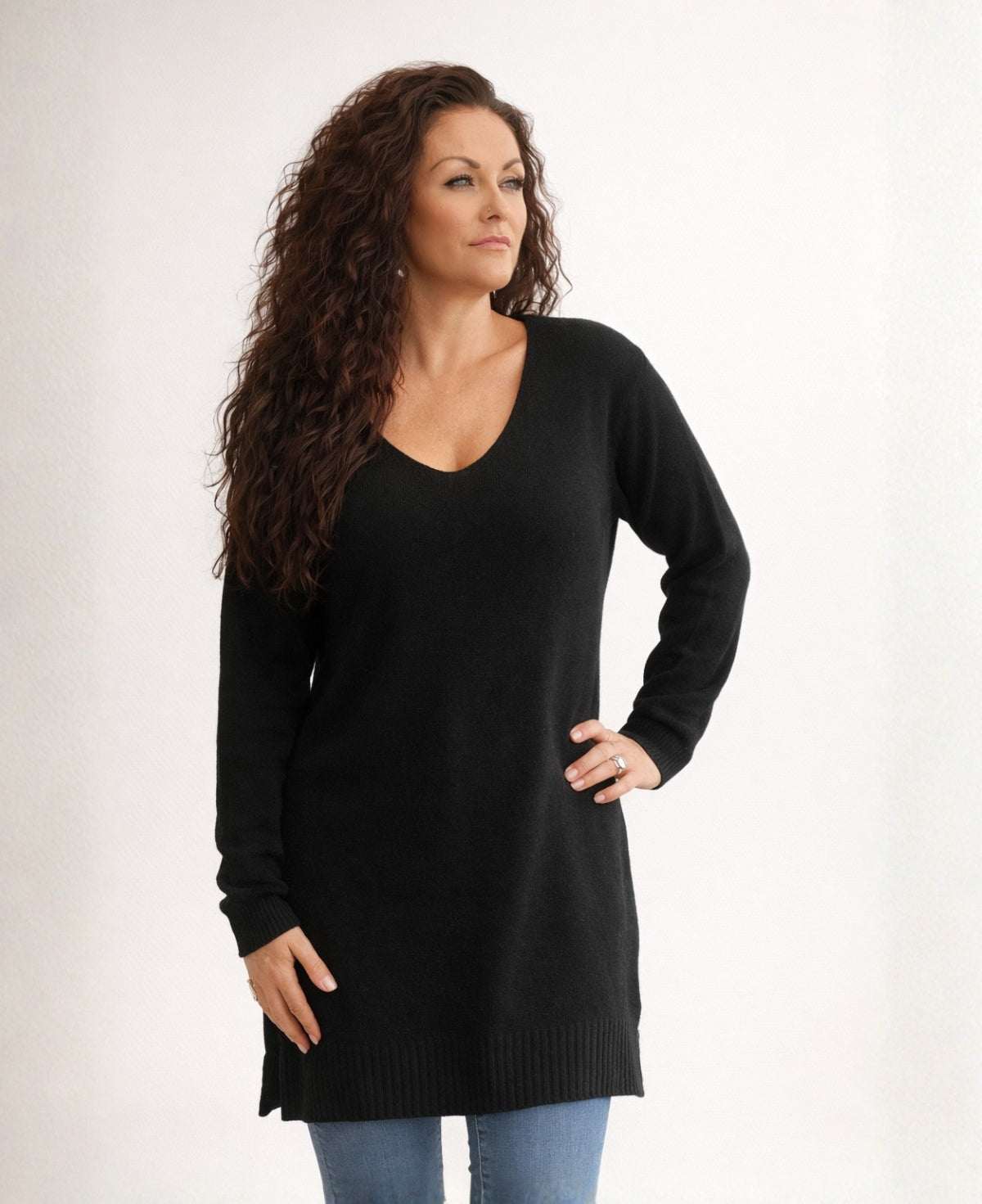 Black long cashmere sweater with V-neck and ribbed hem worn by model, front view