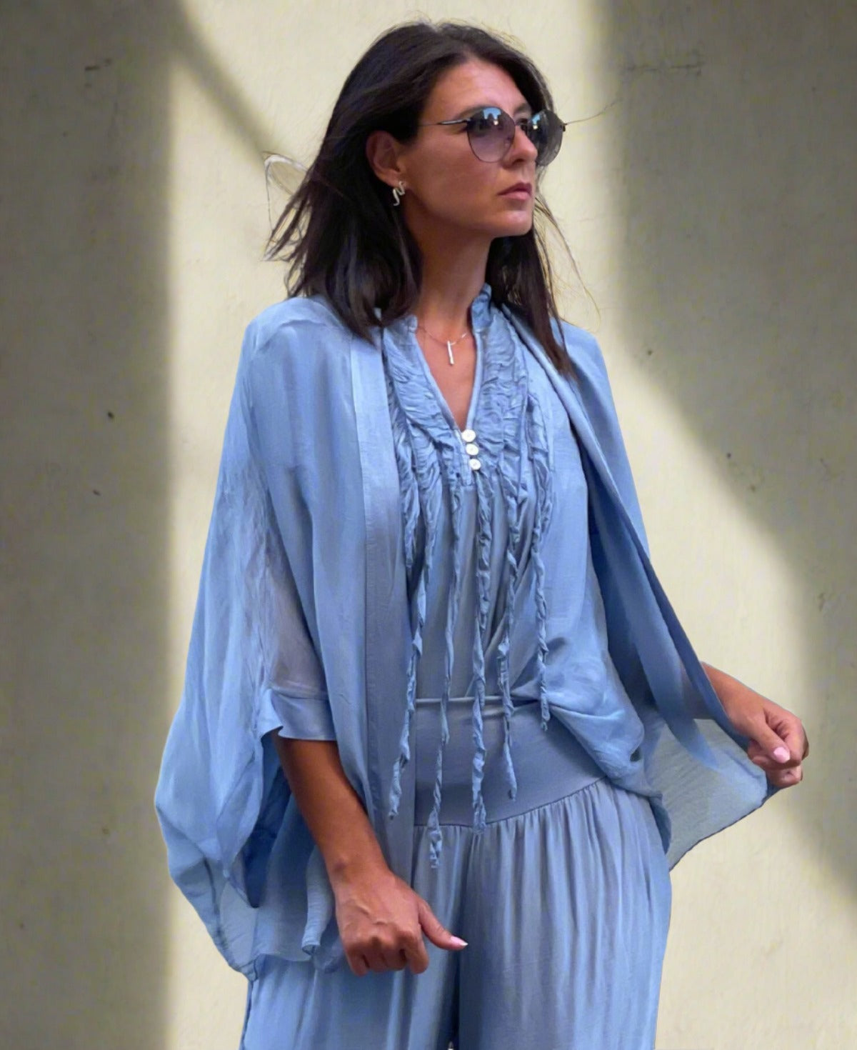 Luxurious silk top featuring airy cap sleeves, a flowing silhouette, and charming ruffle details for effortless sophistication.