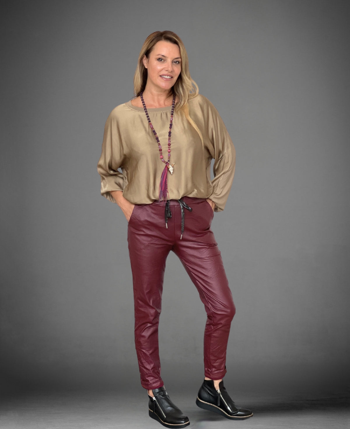 Wine-colored Leatherette Vegan Pants, featuring a sleek, body-contouring fit and ribbed waistband.
