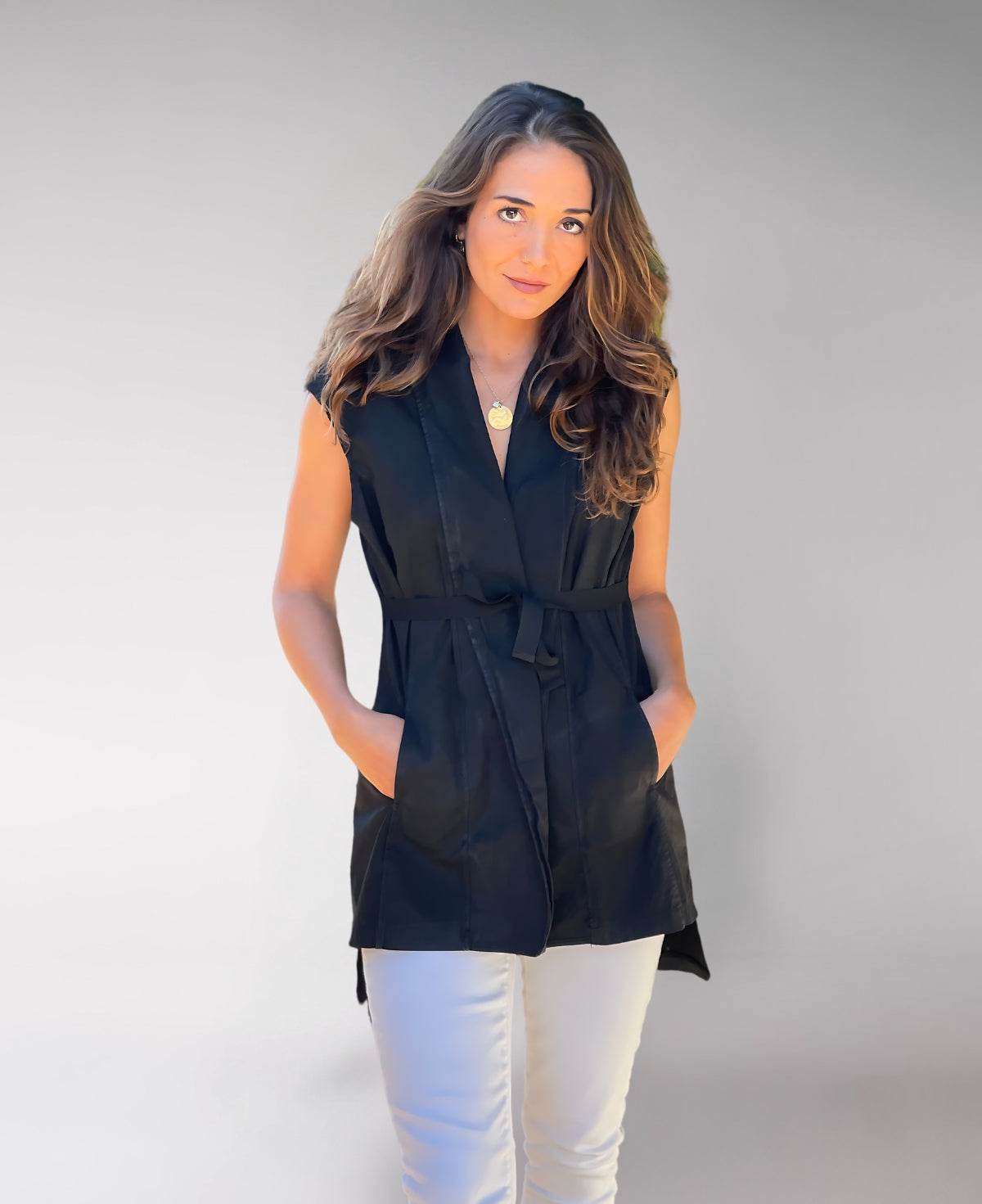 Front view of the black Leia Vest with a flattering silhouette and stylish tie-up waist detail in premium waxed cotton.